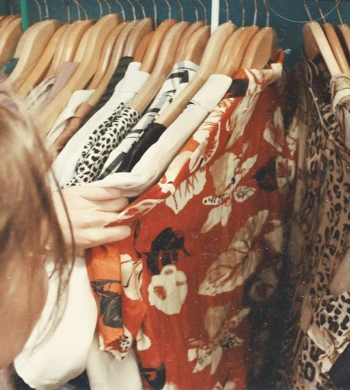 A shopper browsing a rail of patterned clothing